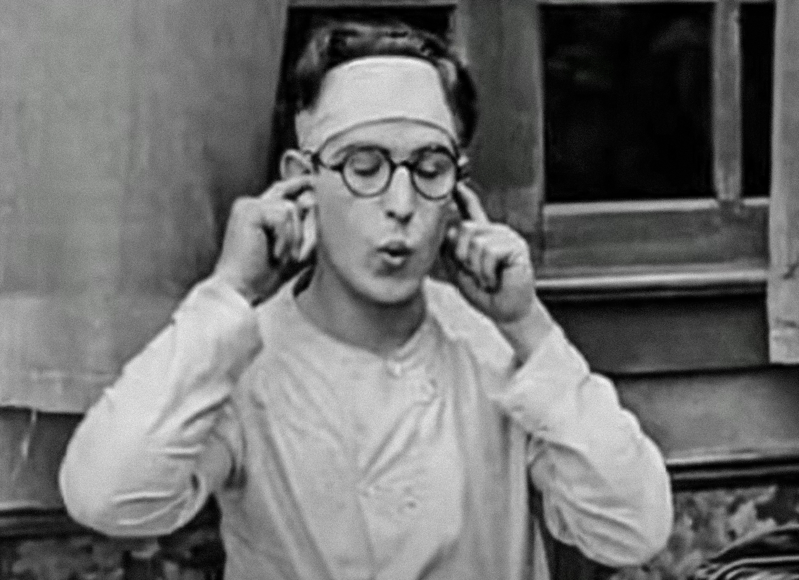 Screenshot B&W - Harold Lloyd wearing white shirt with closed eyes - from Captain Kidd's Kids (1919)