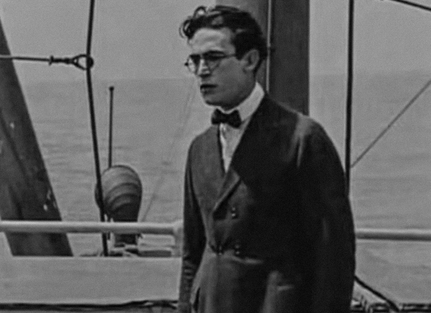 Screenshot B&W - Harold Lloyd wearing black suit and black bow tie - from Captain Kidd's Kids (1919)