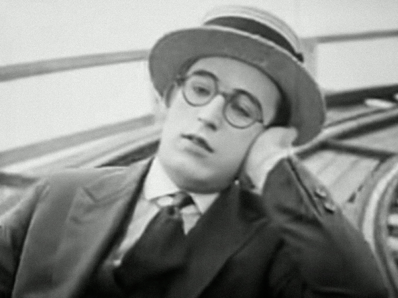 Screenshot B&W - Harold Lloyd  with head over his hand looking sad - from Number Please (1920)