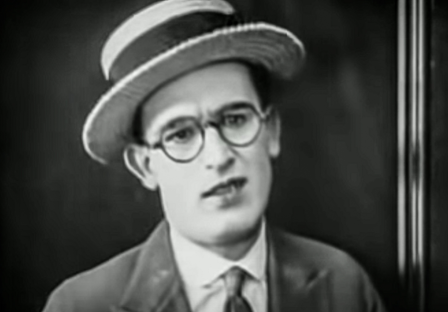 Screenshot B&W - Harold Lloyd looking upset on black background - from Number Please (1920)