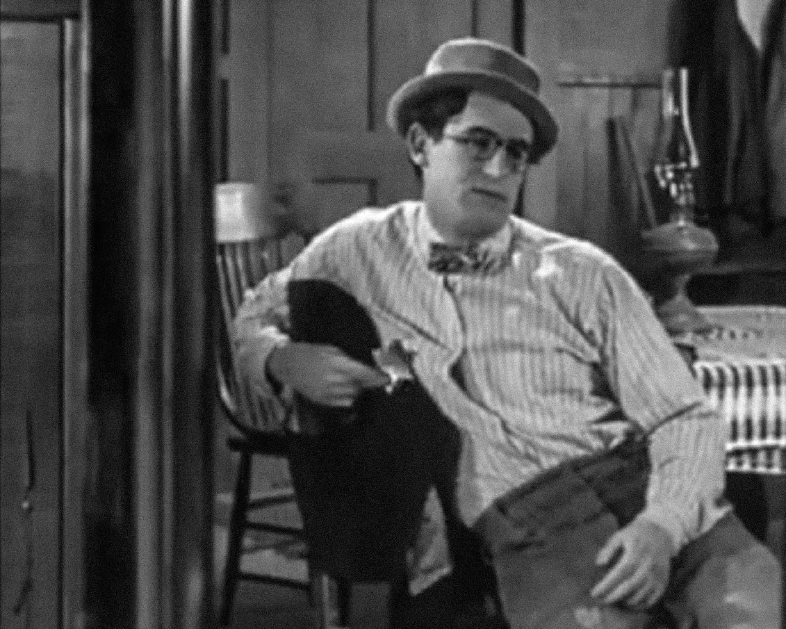 Screenshot B&W - Harold Lloyd seating on the chair and looking sad - from The Kid Brother (1927)