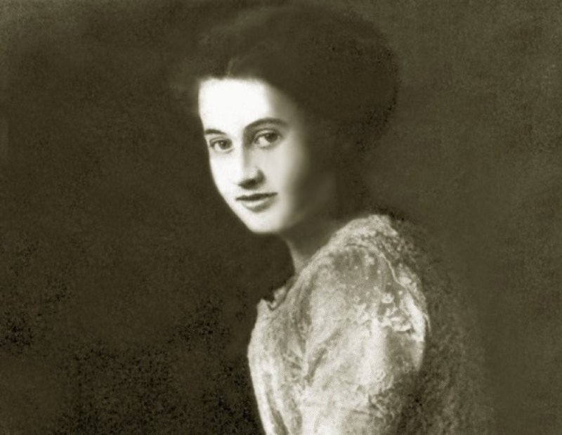 Dorothy smiling and holding a   rose