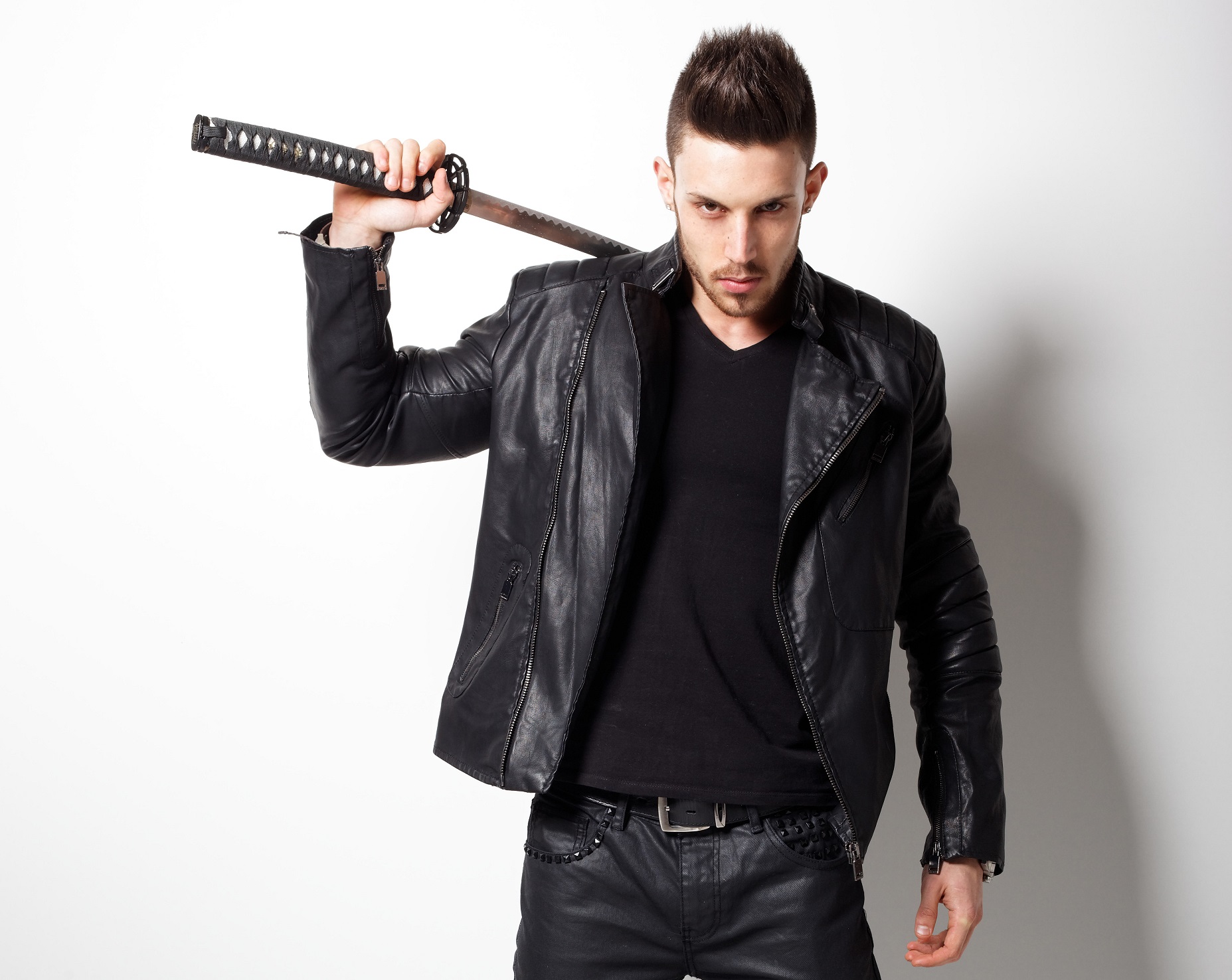 Man holding a samurai sword on the white background.