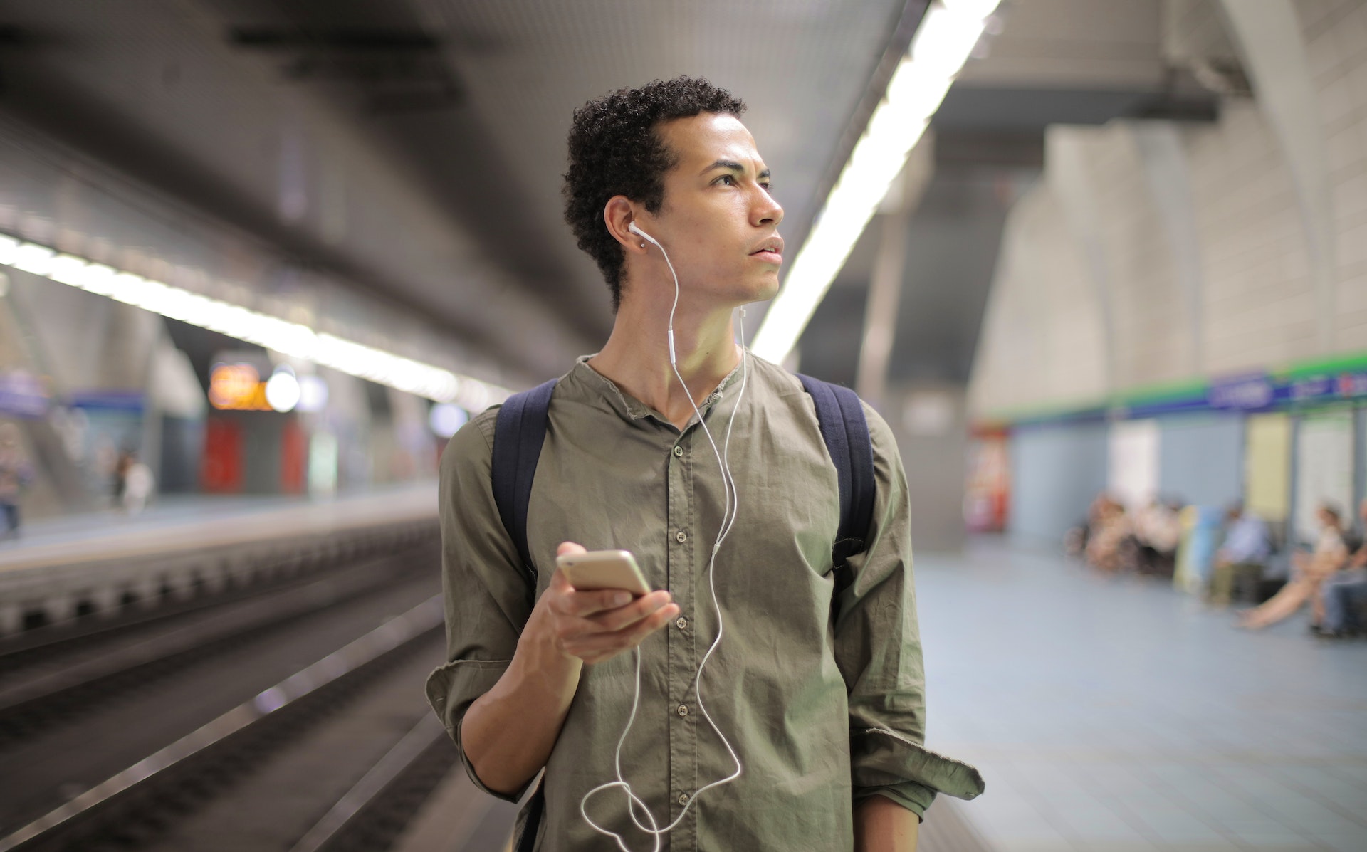 Man speaking on the phone at train station