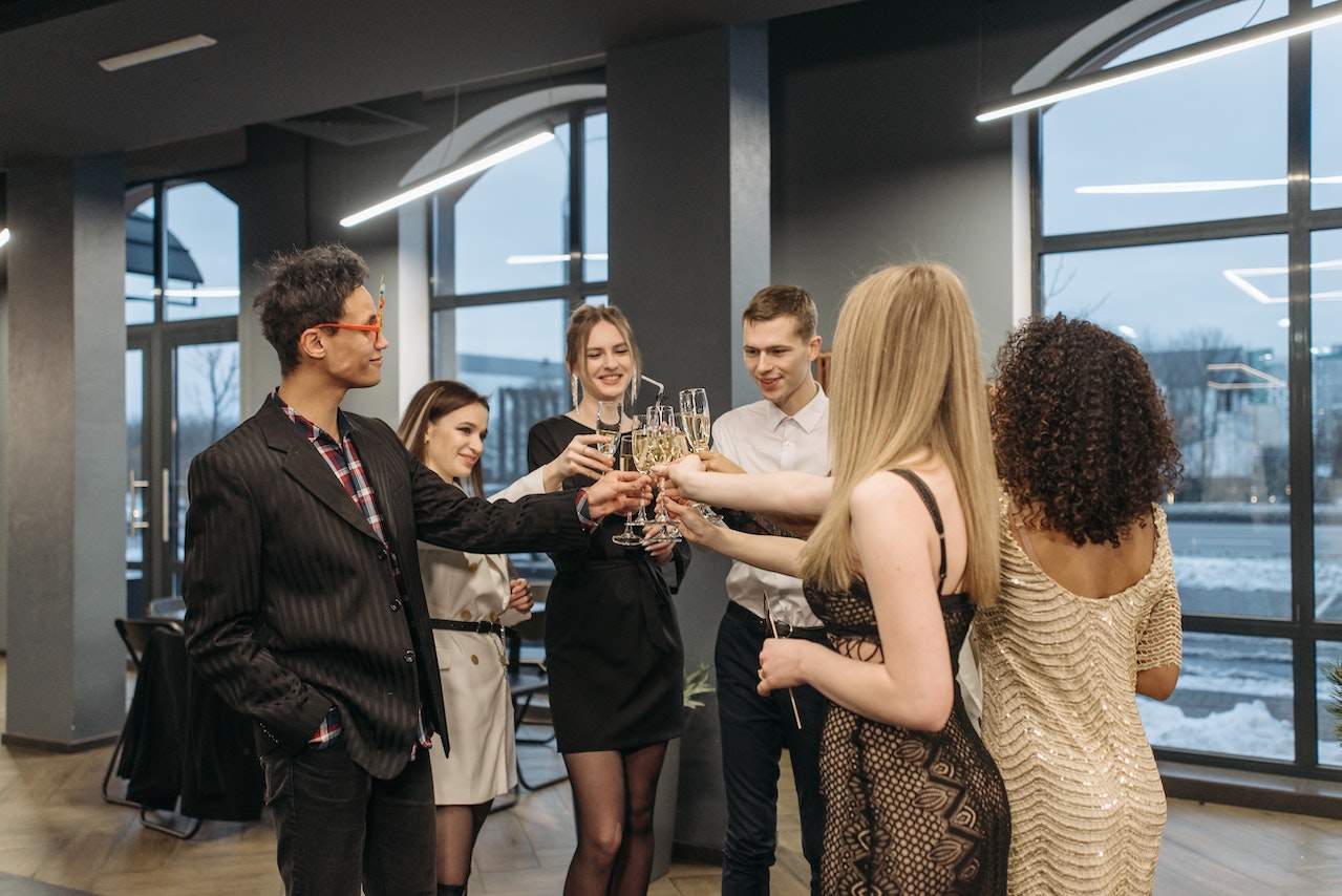 Group of men and women doing glass toast.
