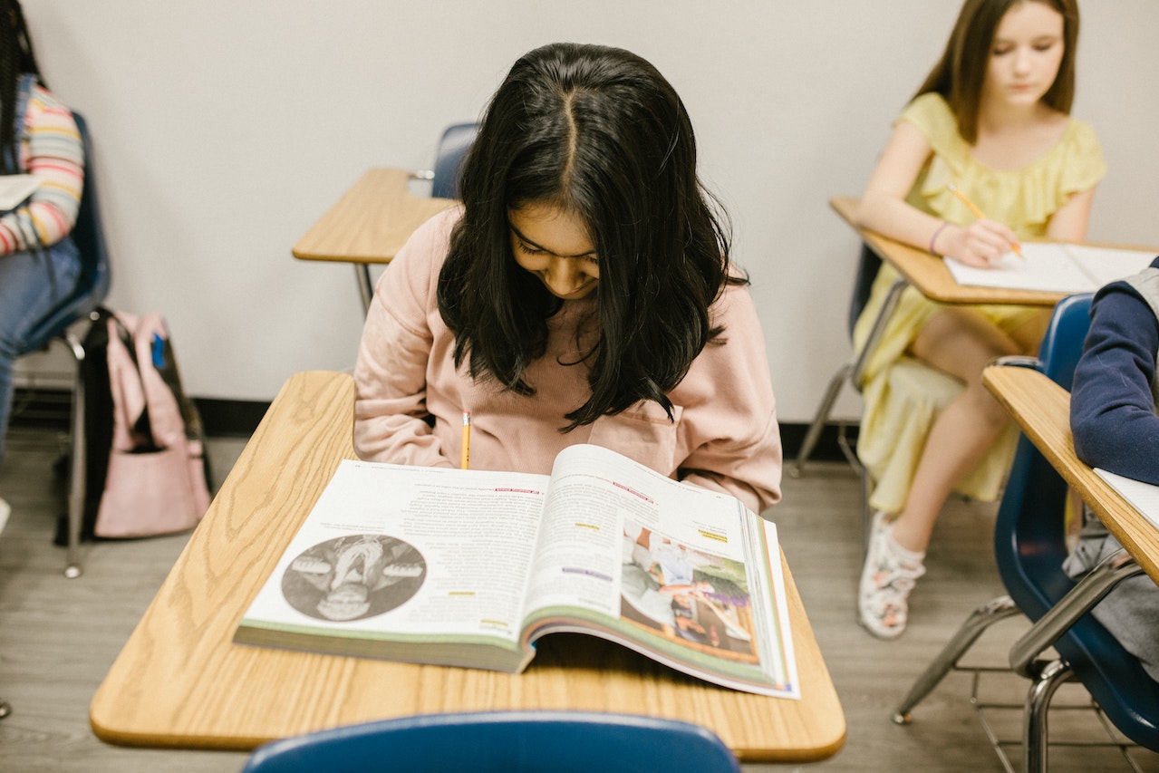 Girl sitting on her desk while studying.