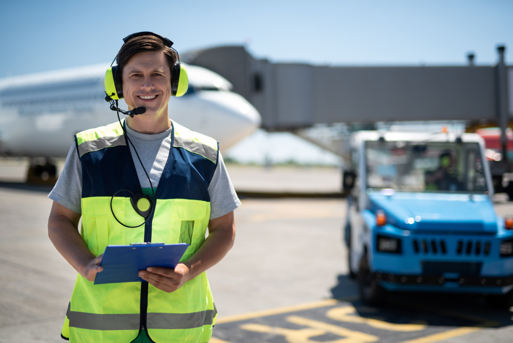 Waist up portrait of smiling airport worker.