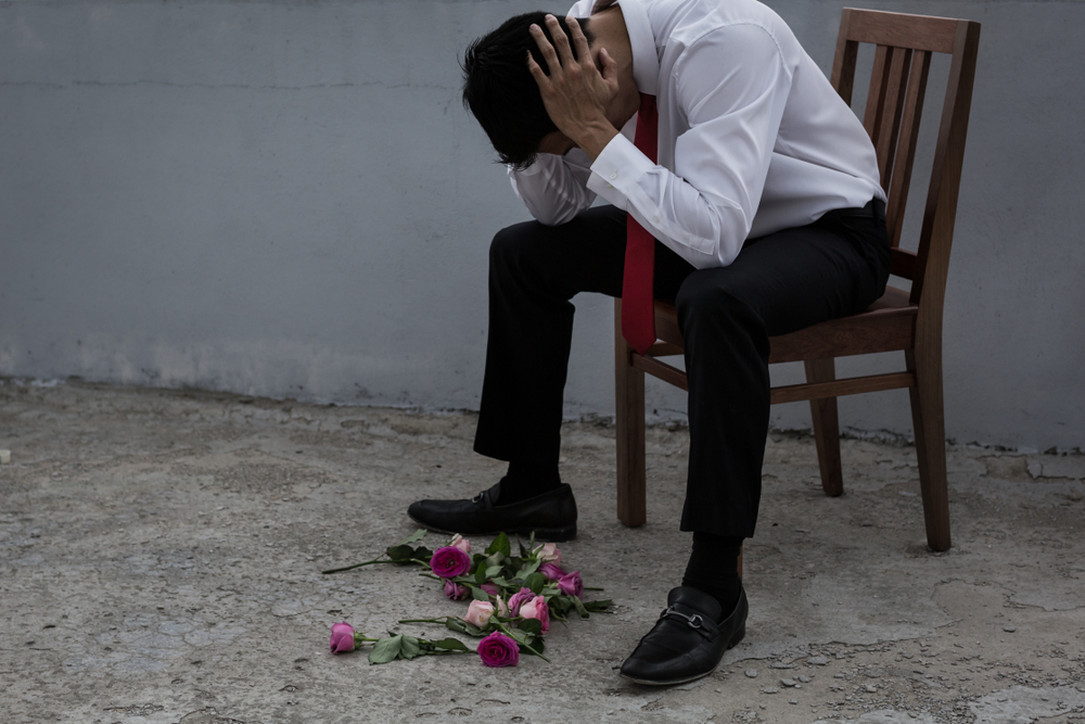 Sad groom sitting on a chair