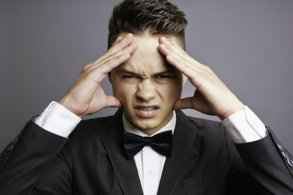 Angry groom holding his head