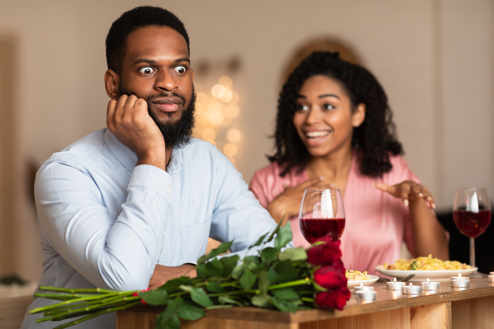 African American Couple Having Unsuccessful Blind Date In Restaurant