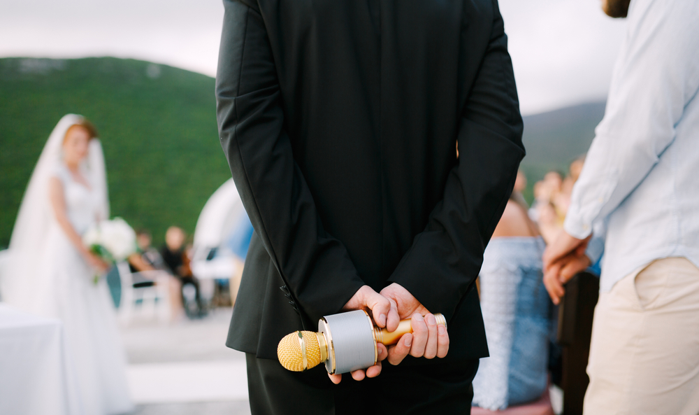 Best man with mic giving speech at a wedding