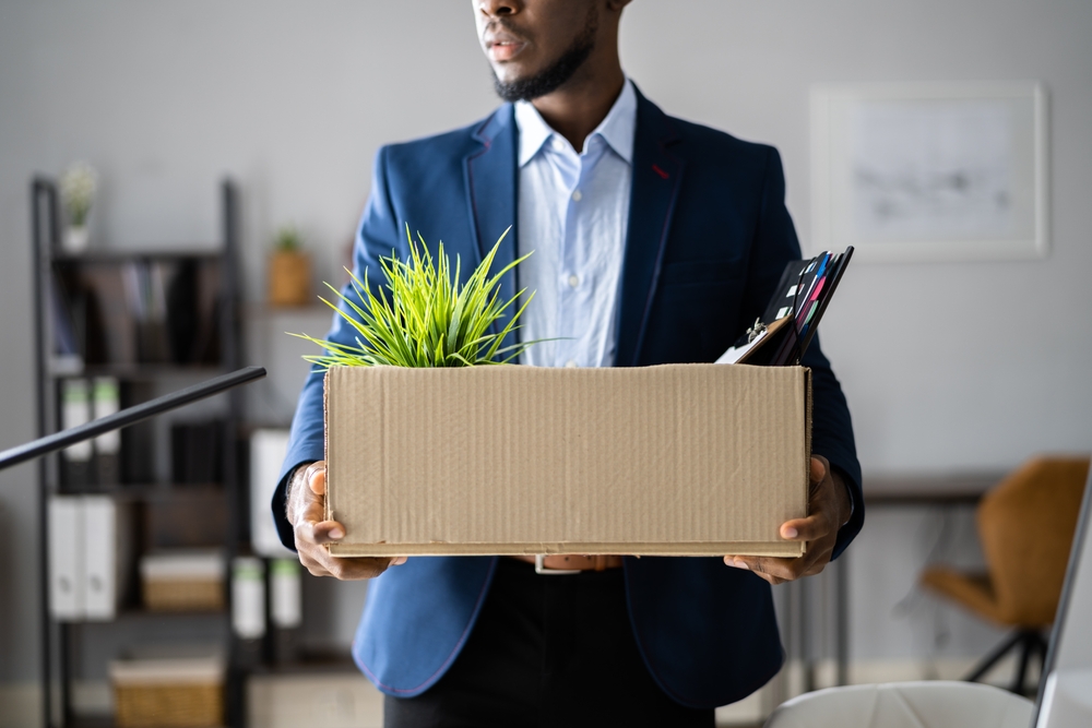 Fired Employee in suit With Box of his stuff