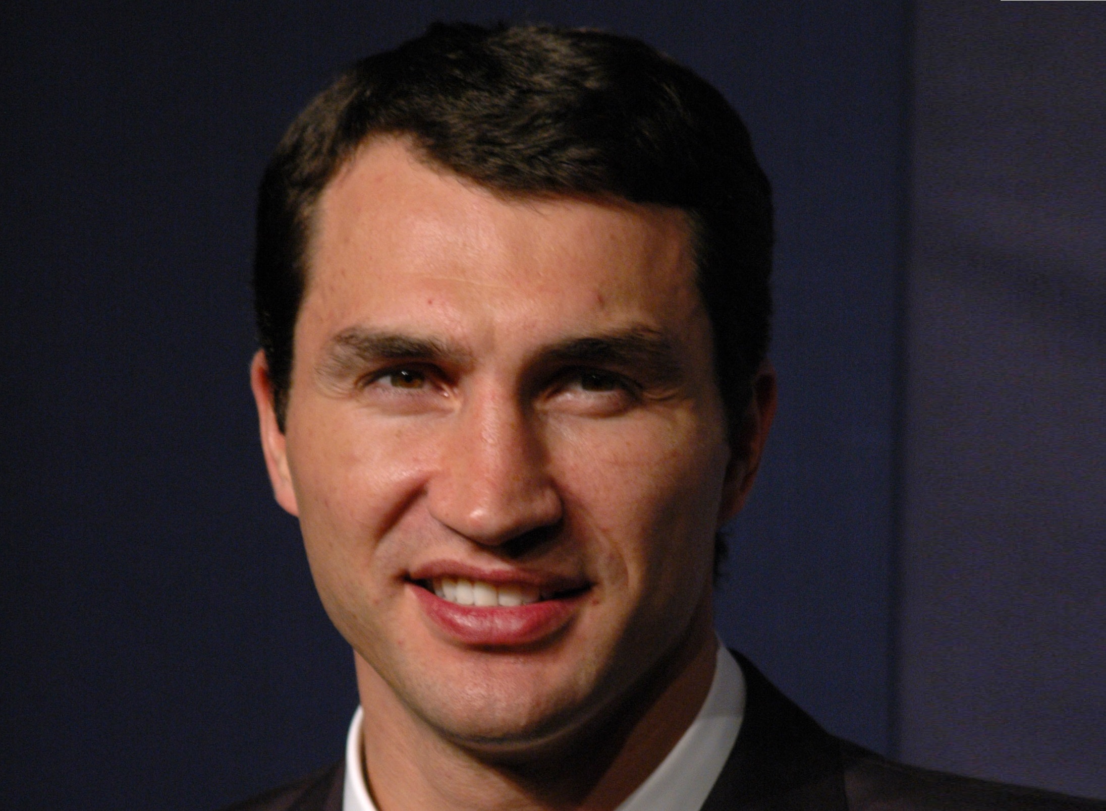 Wladimir Klitschko smiles at the camera on dark background - 2005.