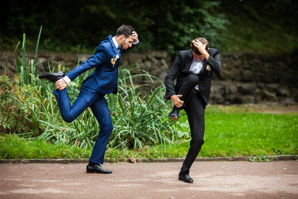 Groom and best man dancing and goofing around
