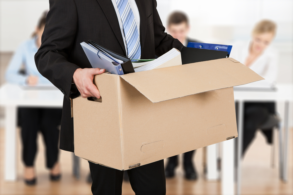 Close-up Of An employee  Carrying Cardboard Box During Office Meeting after being fired