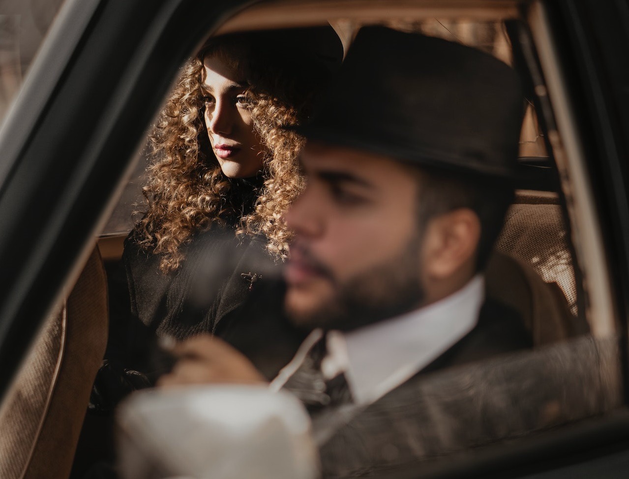 Woman and man seating in the car.