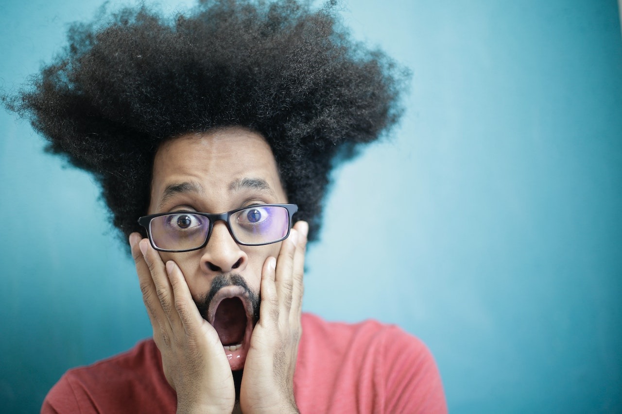 Man looking surprised on the blue background.