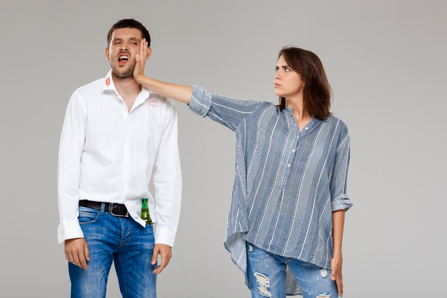 Woman pushing a man on the face.