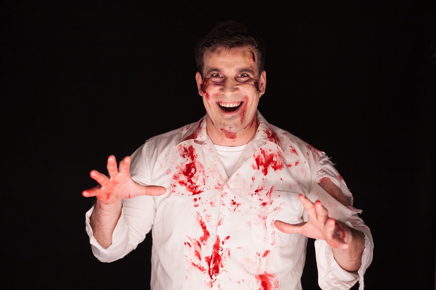 Man wearing white shirt with fake blood.