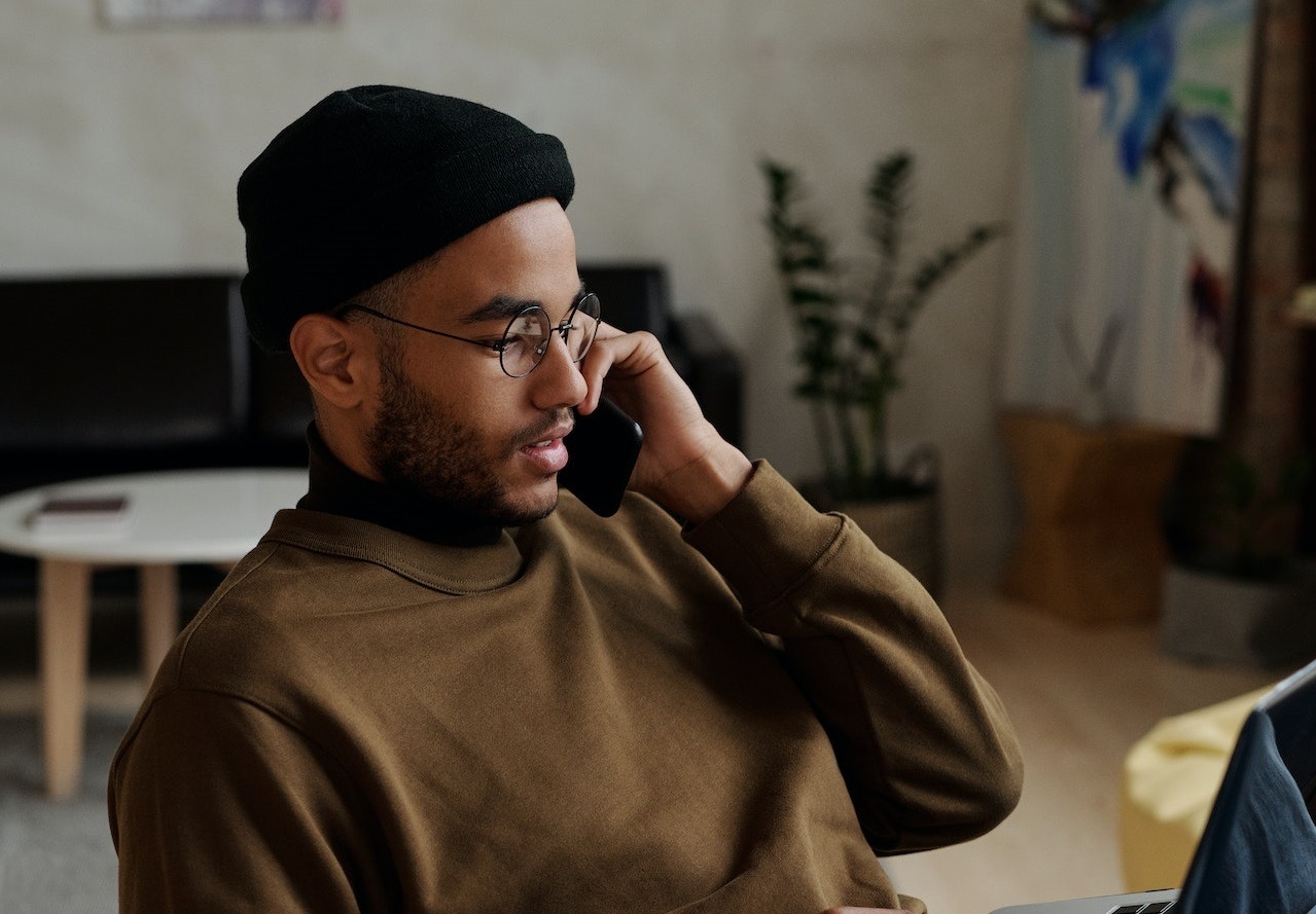 Man talking on the phone looking down.