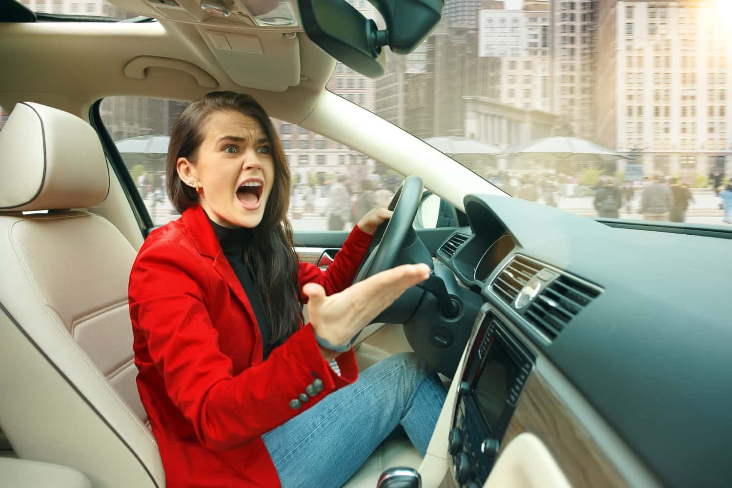 Young woman screaming while driving.