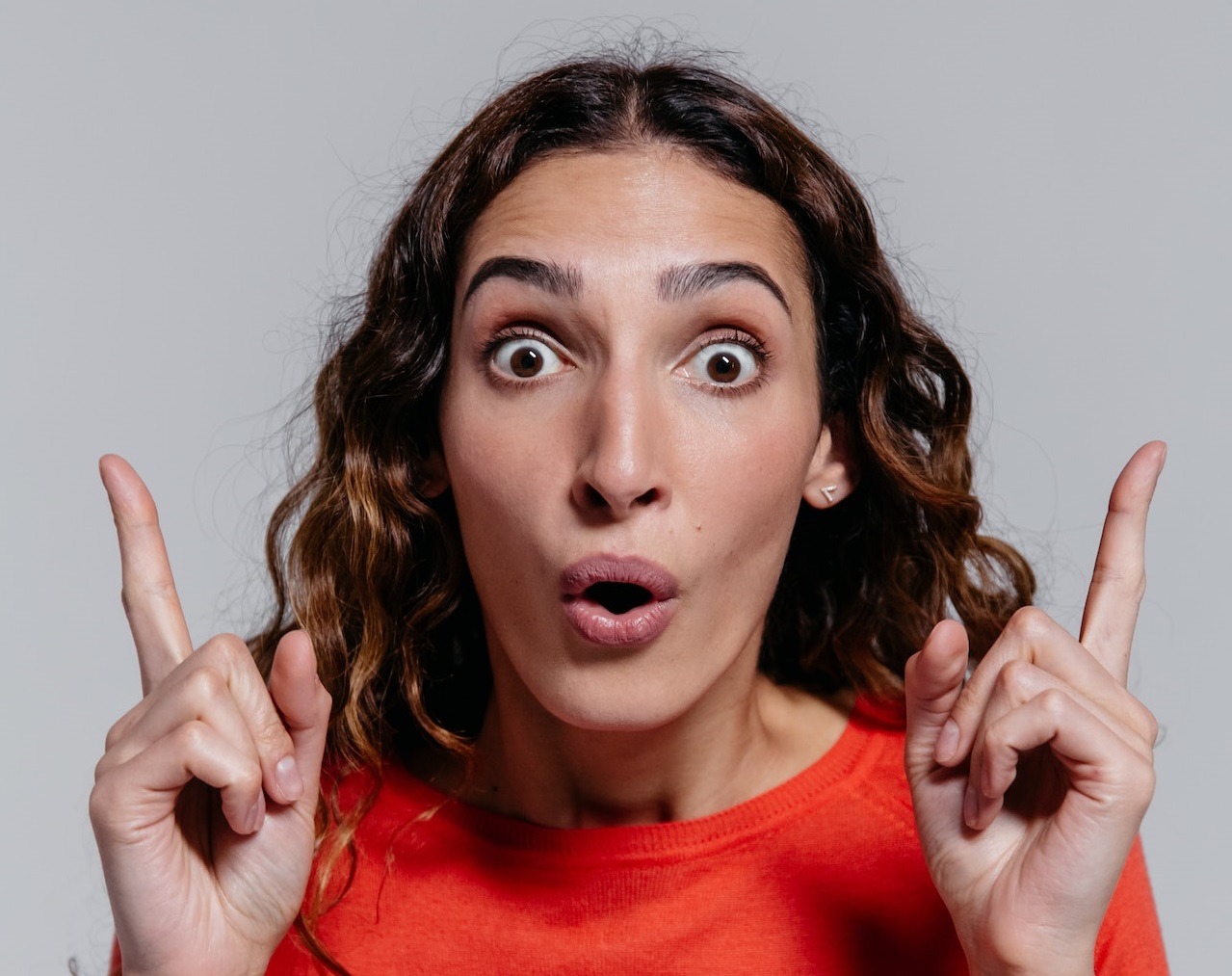 Surprised woman wearing red shirt.