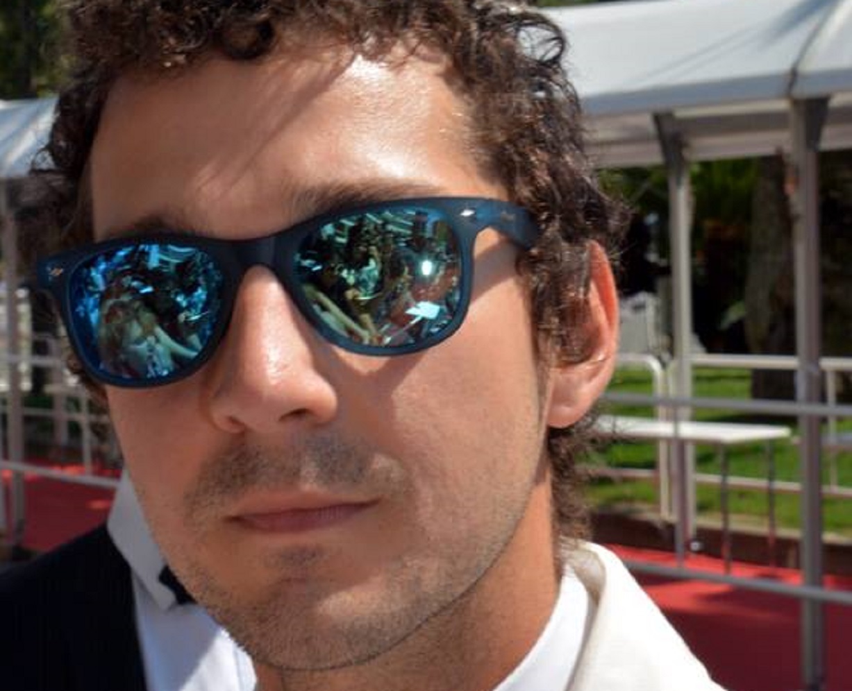 Shia LPortrait Photo of the Actor Shia LaBeouf wearing white jacket and glassesaBeouf wearing white jacket and glasses at Cannes film festival - 2016