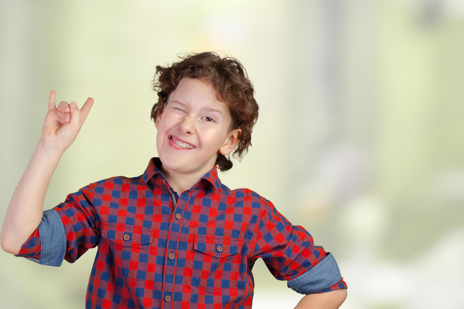 Kid winking with eye ,with raised hand.