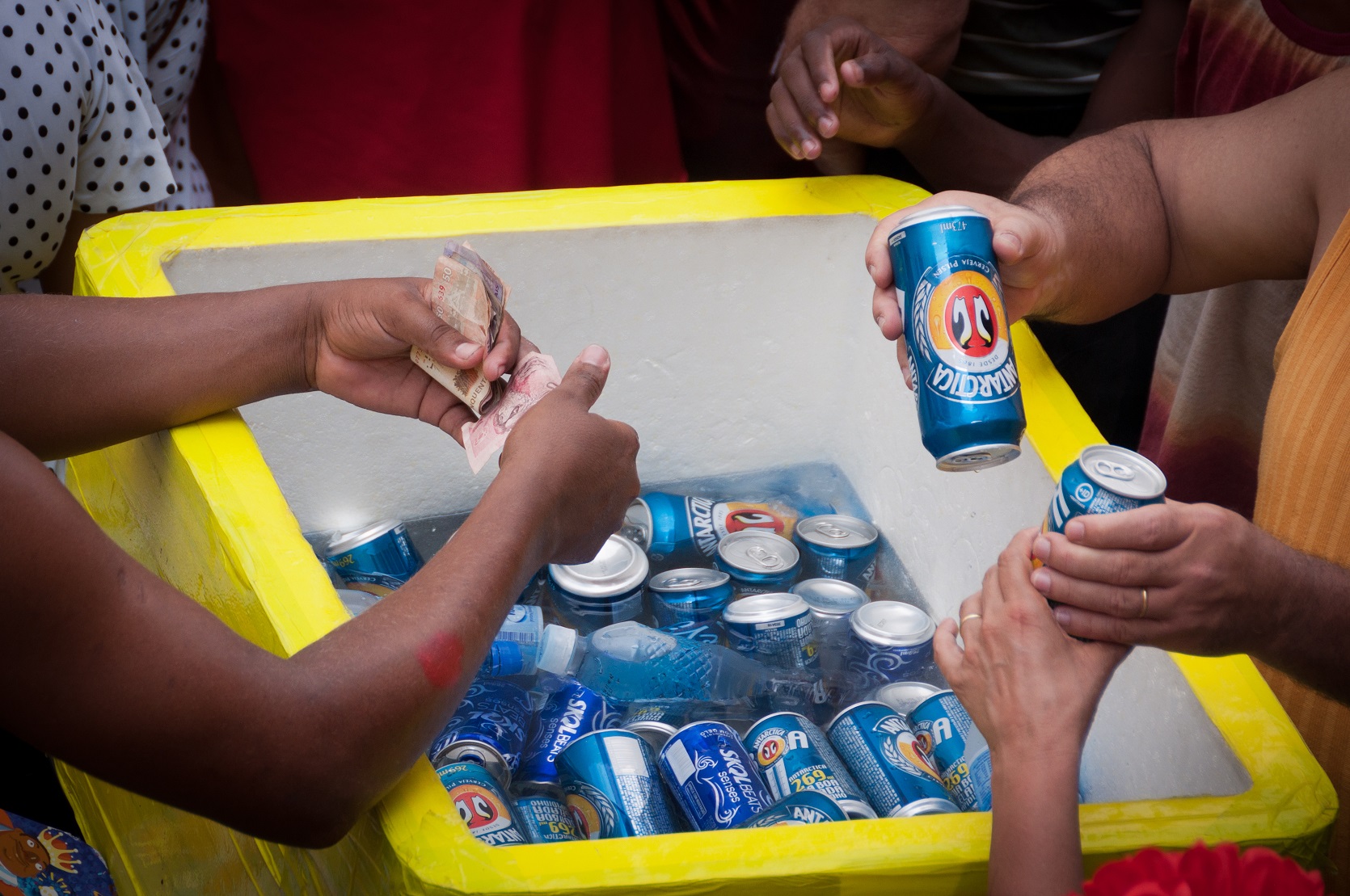 Man selling beer cans in the street.