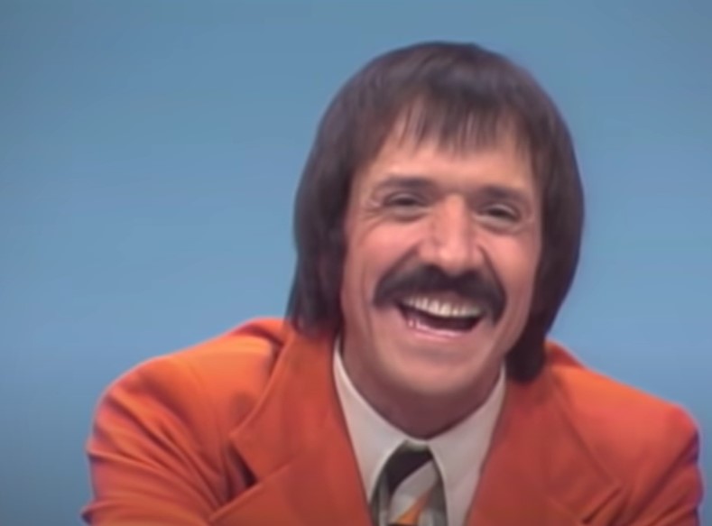 Sonny Bono in  The Sonny and Cher show wearing orange suit