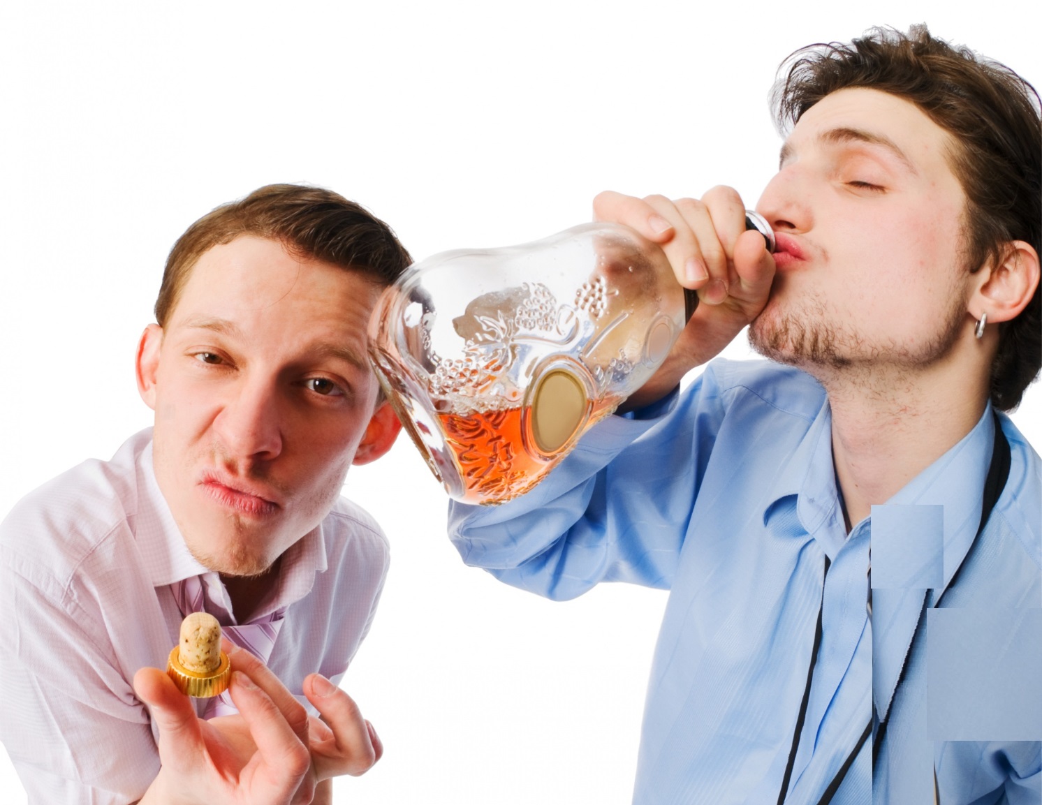 Man is holding a bottle cap in his hand standing at side with man drinking from a bottle.
