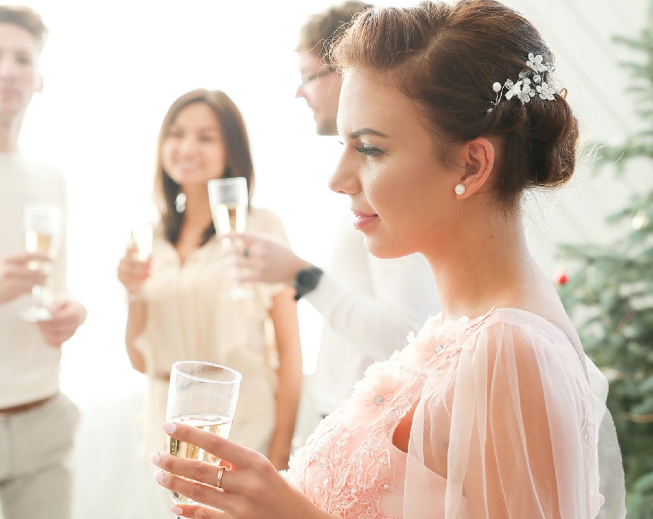 Woman is holding a glass in her hand and looking drunk at wedding.