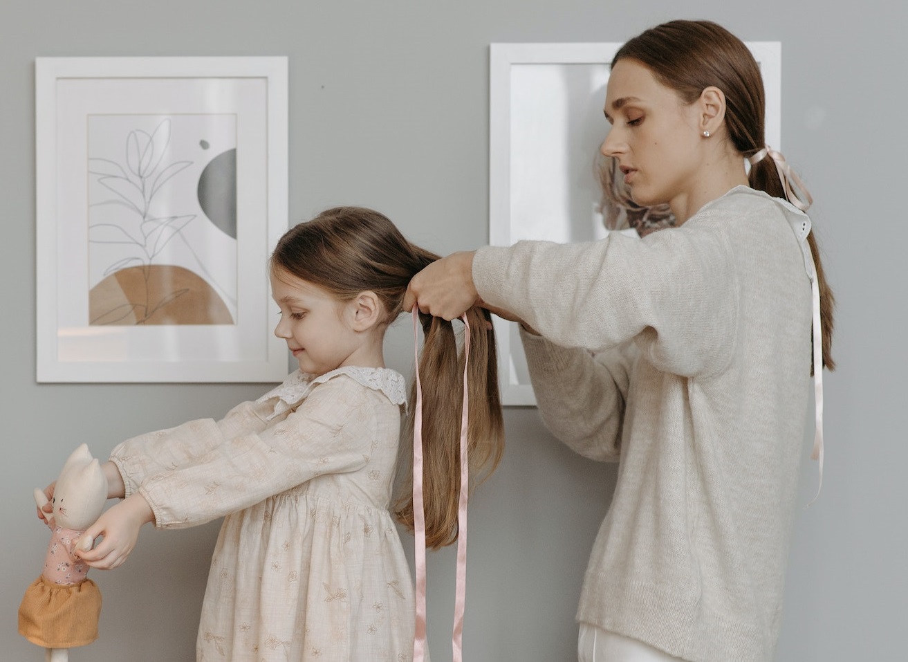 Woman braiding a kid hair.
