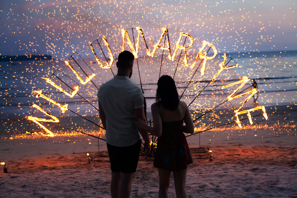 Man proposing marriage to his girlfriend at beach