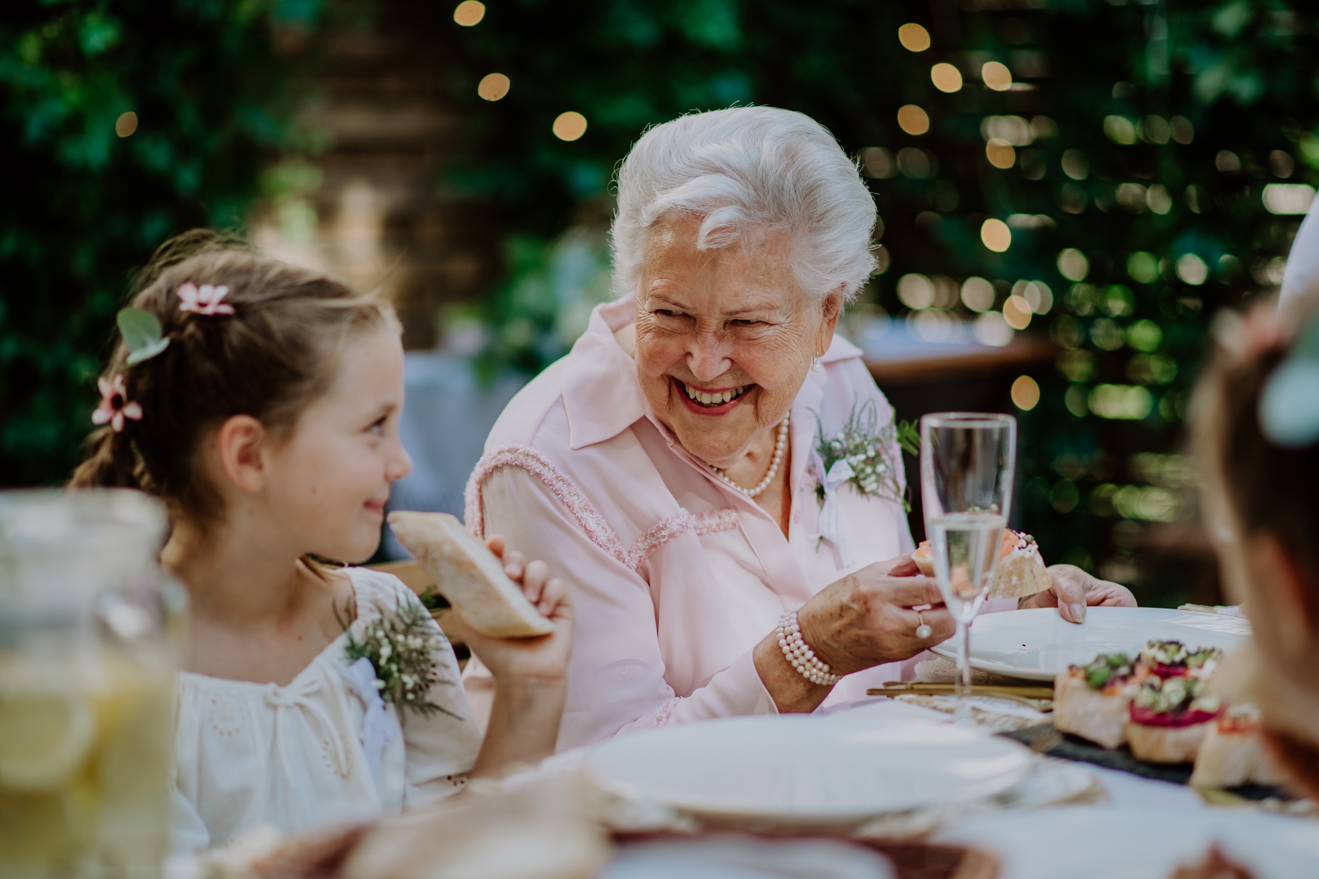 Elder woman smiling and talking with a little girl.
