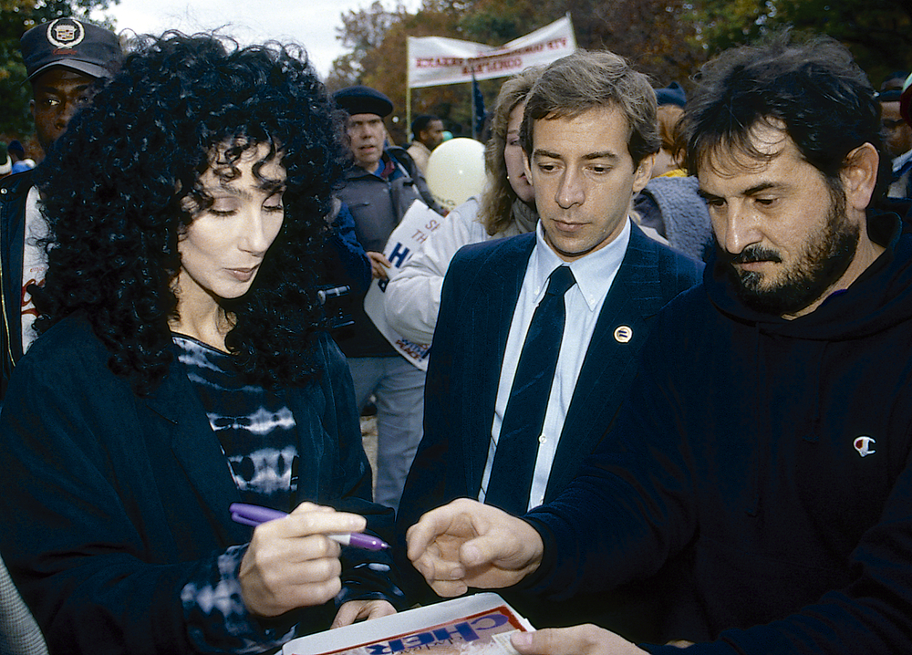 Cher signs an autograph