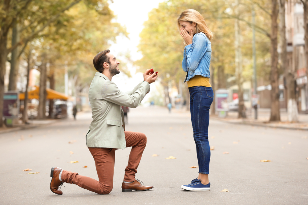 Young man with engagement ring making proposal