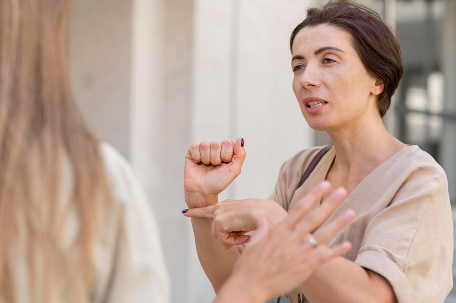 Photo talking and pointing directions with other woman outside.