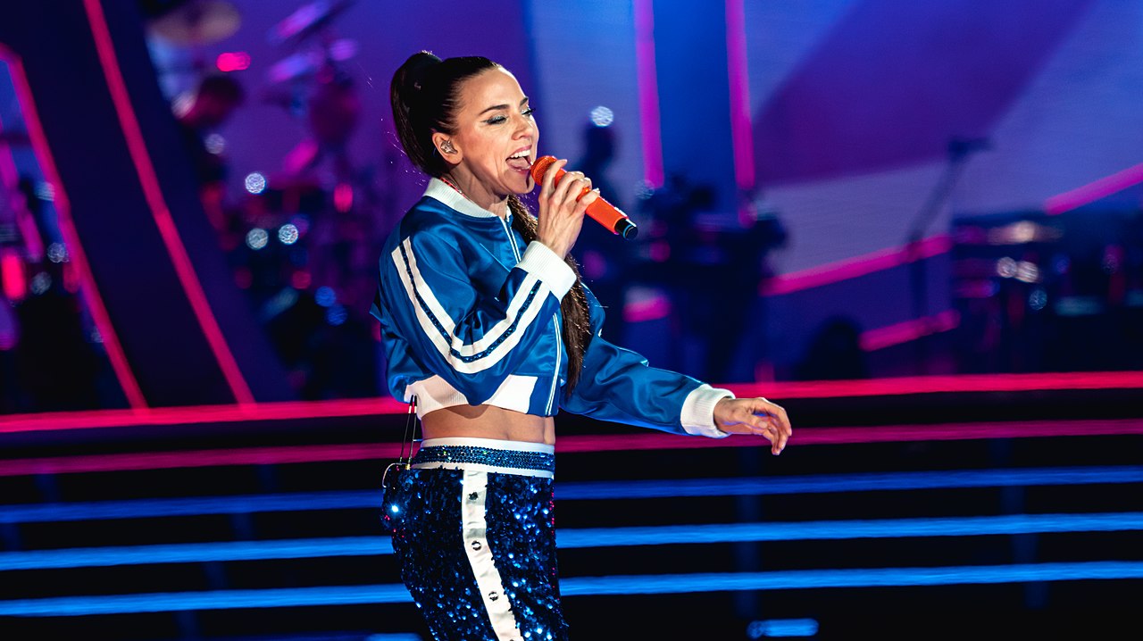 Melanie C in blue tracksuit performing on stage