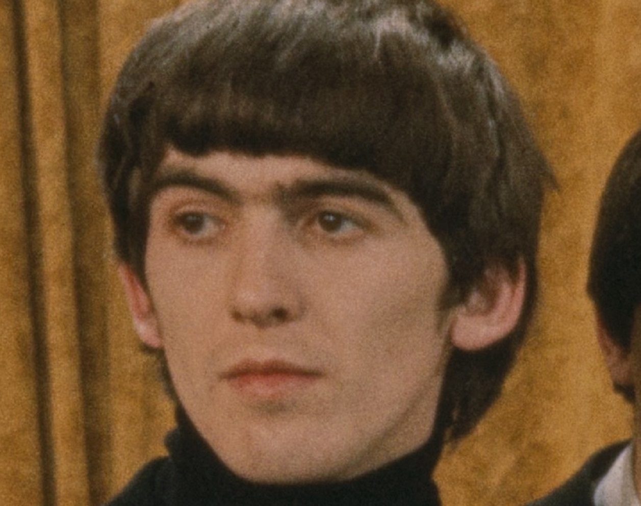 Photo of George Harrison looking at side - 1964