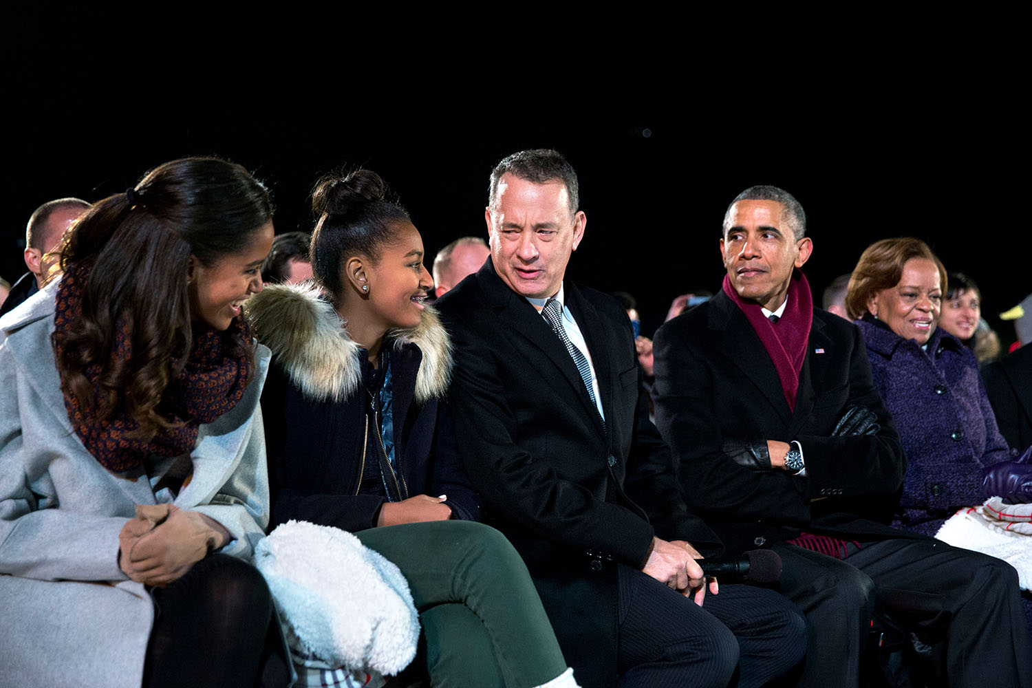 President Barack Obama, seated with daughters Malia and Sasha, Tom Hanks and Marian Robinson