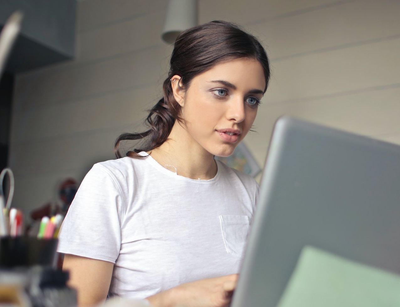 Young woman is working on her laptop at office.