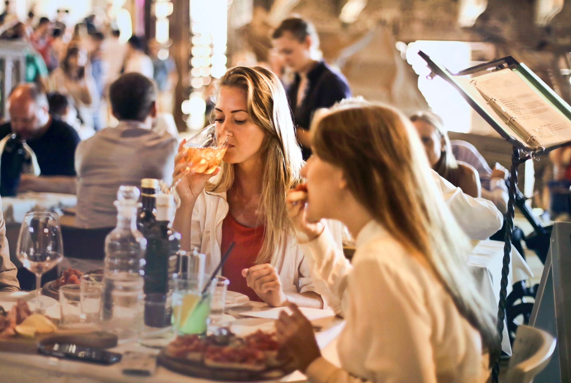 Two girl sitting at restaurant table  having a meal