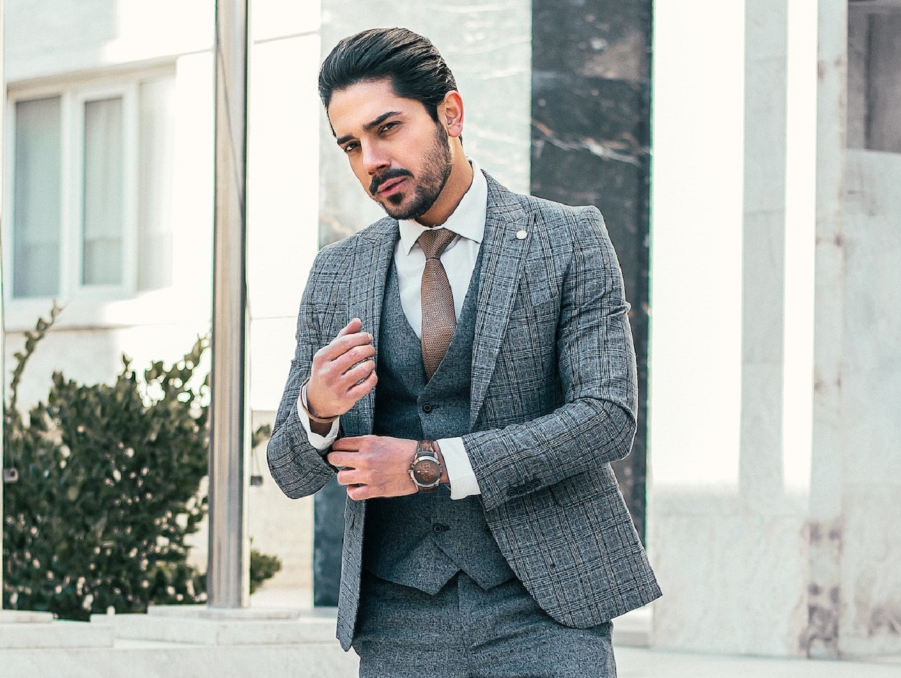 Young businessman is walking downstairs on street.