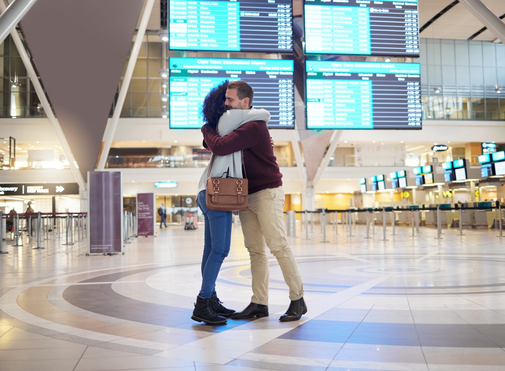 Couple, hug and says goodbye at airport for travel, trip or flight in  long distance relationship