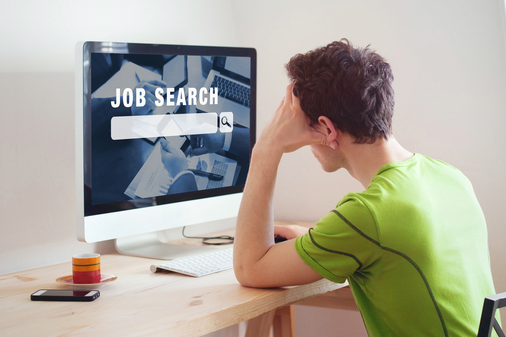 man at home looking for a job on internet