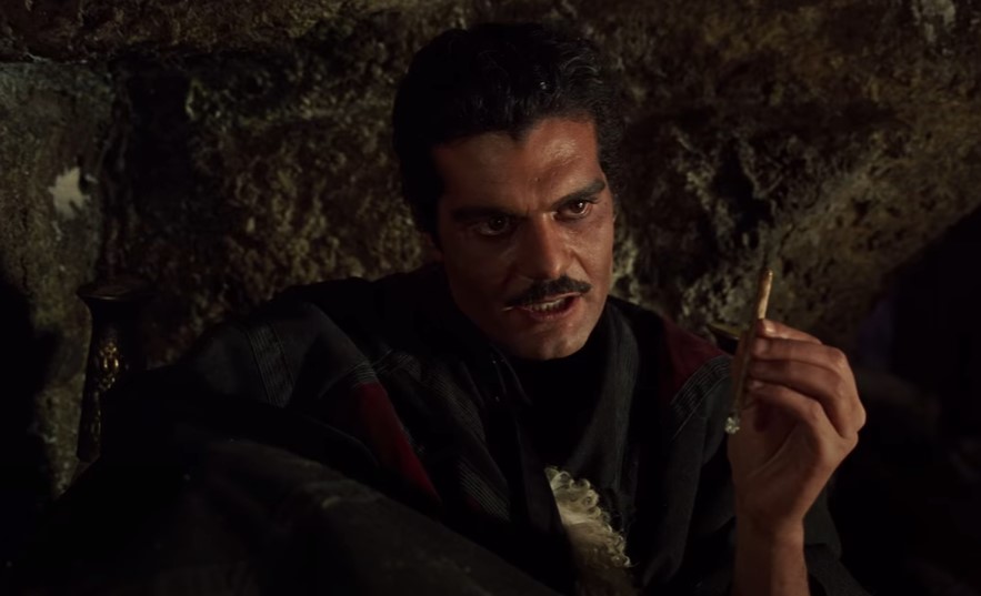 Omar Sharif in Lawrence of Arabia in a cave in dark clothes