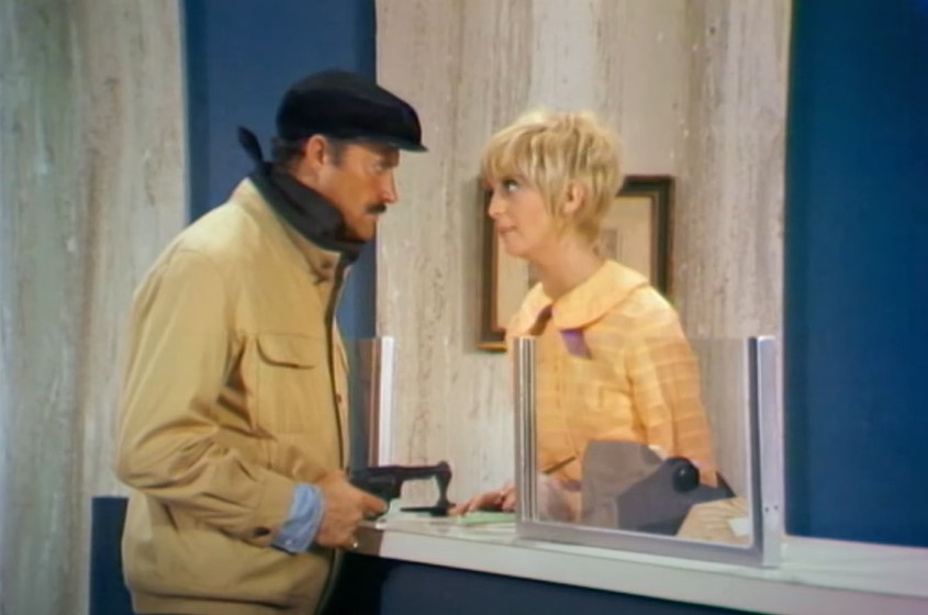Goldie Hawn  as a Bank Teller  in Rowan & Martin's Laugh-In, standing behind bank counter