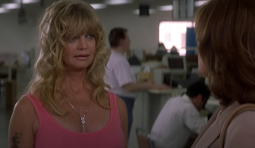 Goldie Hawn in pink top speaking to Susan Sarandon in The Banger Sisters