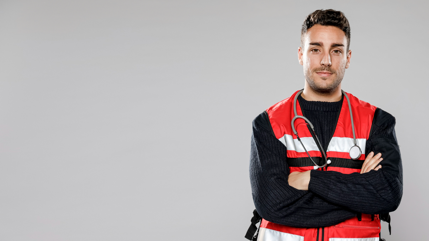 Photo of male wearing paramedic uniform looking at camera.